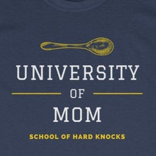 Load image into Gallery viewer, Navy tee shirt with yellow spoon and embellishments and white and yellow wording: University of mom, school of hard knocks